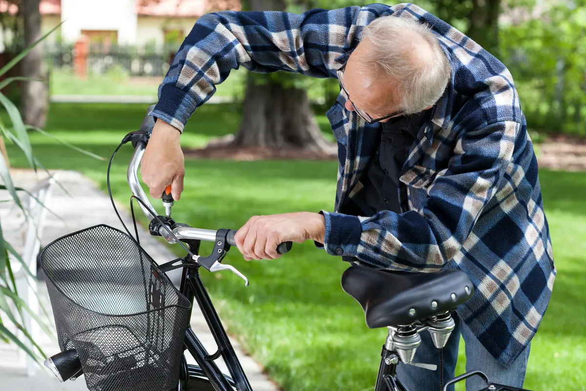 Rider adjusting the handlebar of a bicycle outdoors
