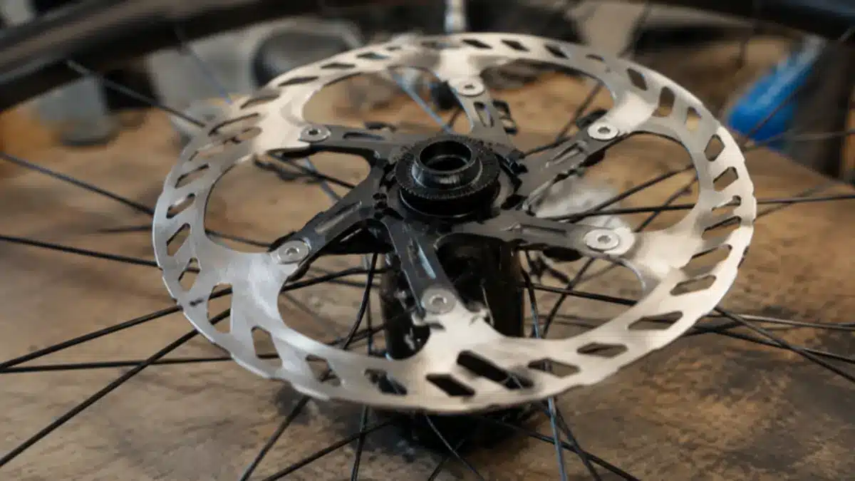 Center Lock disc rotor with a black two-piece carrier seated on a bicycle hub, held by a single externally notched lockring