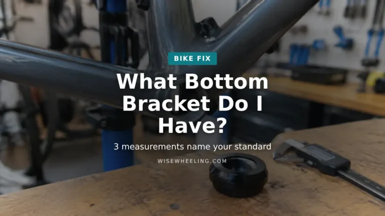 Empty bottom bracket shell on a bike frame in a repair stand with a bottom bracket cup and digital caliper on the bench