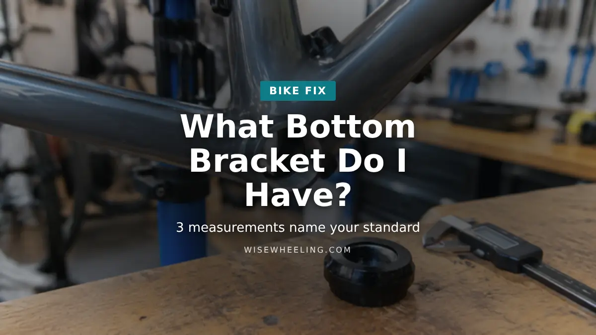 Empty bottom bracket shell on a bike frame in a repair stand with a bottom bracket cup and digital caliper on the bench