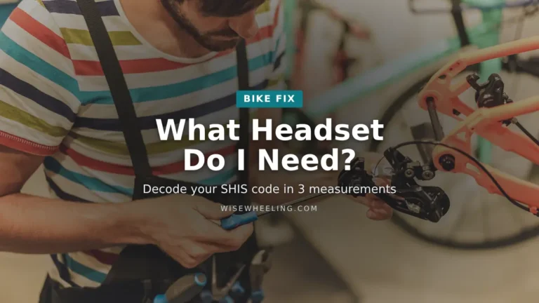 Bike mechanic working on a bicycle in a workshop, with the title What Headset Do I Need?